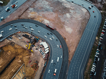 Construction of a tunnel under the motorway. Construction of a traffic interchange. Drone view. Diversions of the construction site.の写真素材