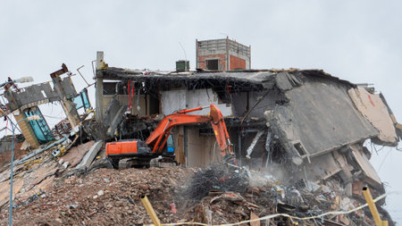 Heavy equipment being used to tear tearing down building construction
