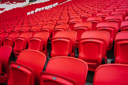 Rows of seats in a football stadium. Bright red stadium seats.の写真素材