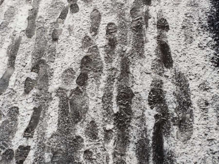 Footprints in the snow. Snow-covered sidewalk. Exceeded the norm of precipitation.の写真素材