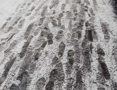 Footprints in the snow. Snow-covered sidewalk. Exceeded the norm of precipitation.の写真素材