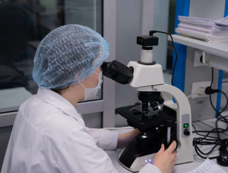 Kazan, Russia. May 10, 2022. Researcher looking through microscope in laboratoryのeditorial素材