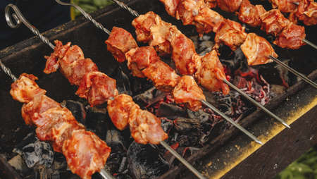 Pork shish kebab cooked on the grill. Pieces of meat marinated in sauce.の写真素材