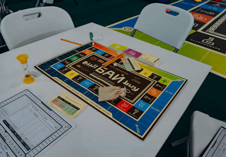 Kazan, Russia. May 19, 2022. Top view of Tatar game BUY (copies of the game monopoly) on wooden table.のeditorial素材