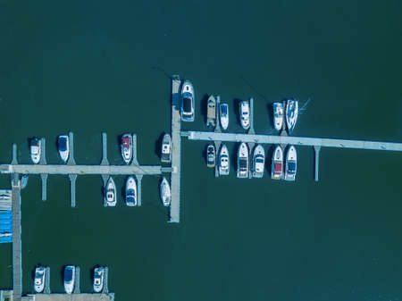 Boat and yacht parking. A marina lot. Yacht and sailboat is moored at the quay.の写真素材