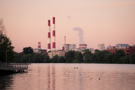 A thermal power plant at dawn. Reflection of pipes and cooling towers in the water. Kazan, Russia.