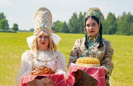 Kazan, Russia. 2022, June 18. Meeting guests according to Tatar customs. Girls offer to taste the chak-chak.のeditorial素材