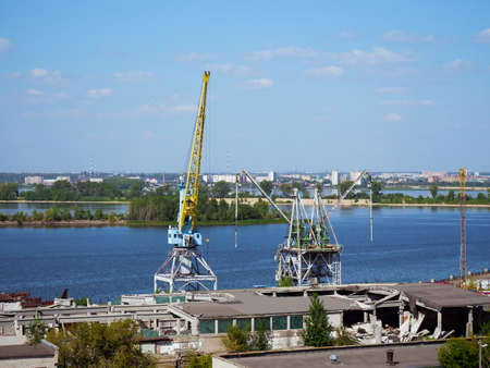 Port cranes on the Volga River, Russia. Freight river transport infrastructureの写真素材