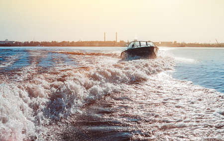 Motor boat breaking the waves. Summer vacation on the water.の写真素材