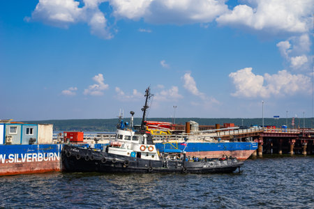 The tug is moored around the barge.のeditorial素材