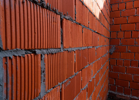Brick wall of rough masonry. Large bricks in close-up. Walls in roughing. Brick wall texture.の写真素材
