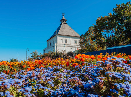 The Tainitskaya Tower of the Kazan Kremlin surrounded by flowers. The Kremlin is a popular tourist attraction in Kazan, Tatarstan Republic, Russia.の写真素材