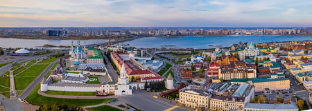 A view of the Kazan Kremlin with the Qul Sharif Mosque, Preobrazhensky Cathedral and Suyumbike Tower. Spasskaya Tower - the main entrance to the Kremlin. Cityscape with the Kazanka River at sunsetの写真素材