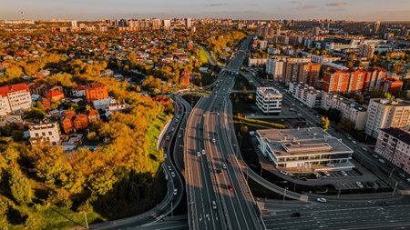 Heavy traffic car junction. Drone shot at a highway. A wide highway in the middle of the city at sunsetの写真素材