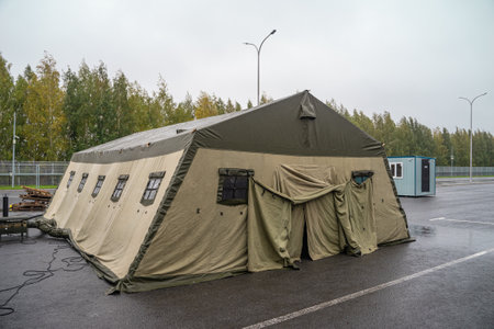 Military tent. Military base with temporary barracks. Exercises of the soldiers. Army camp.の写真素材