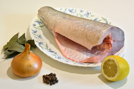 Fish for cooking on a platter and spices.の写真素材
