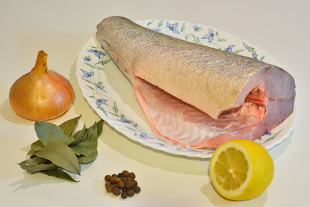 Fish for cooking on a platter and spices around.の写真素材