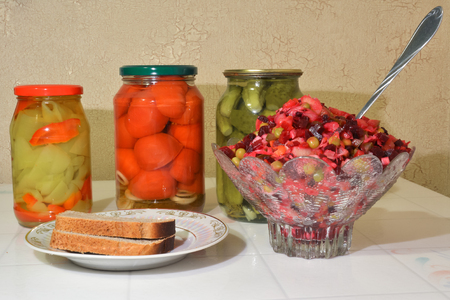Vase with vinaigrette, a plate with bread, homemade pickles.の写真素材