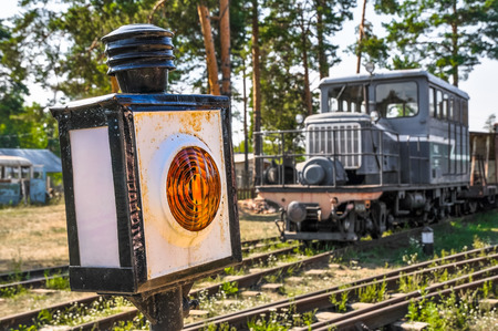 Yellow semaphore and the locomotive on the railway.のeditorial素材