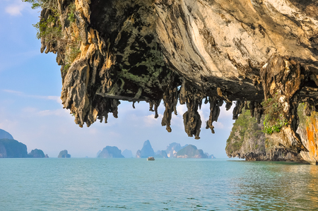 Boat floats among the karst islands in Phang Nga Bay.の写真素材
