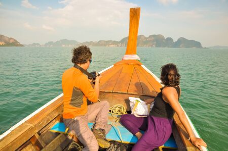 Man and woman floating in a boat among the islands.の写真素材