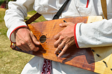 Man plays an ancient traditional Russian musical instrument - gusli.の写真素材