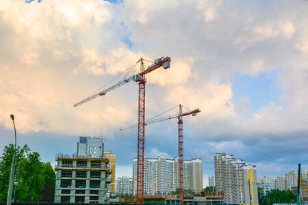 Cranes are on the construction site of residential buildings.の写真素材