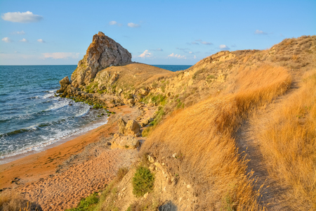 Path to the picturesque sea shore with a rock.の写真素材