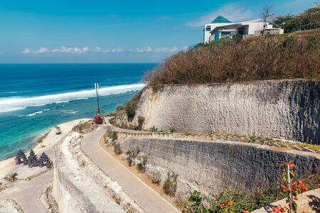 Beautiful view of Melasti Beach. Blue sea with waves, clear sky and white sand in Indian Ocean,...