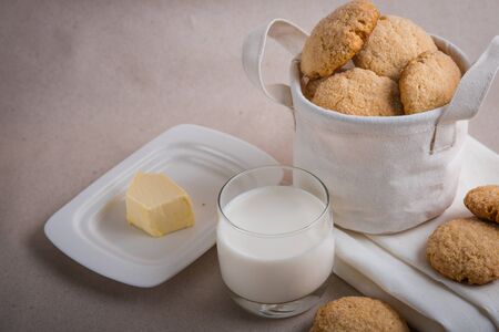 homemade biscuits in a linen basket on a beige background. cracked cookies. Healthy sweets cooking for family.の写真素材