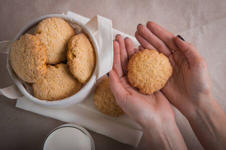 homemade biscuits in a linen basket on a beige background. cracked cookies. Healthy sweets cooking for family.の写真素材