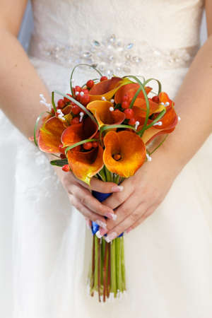 The bride's bouquet on the background of the dress.の写真素材