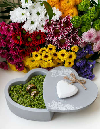 wedding rings in moss, in the gray box in the shape of a heartの写真素材