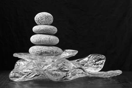 the stones balance on glass. concept of balance and harmony. Spa stones treatment scene, rock zen like conceptsの写真素材