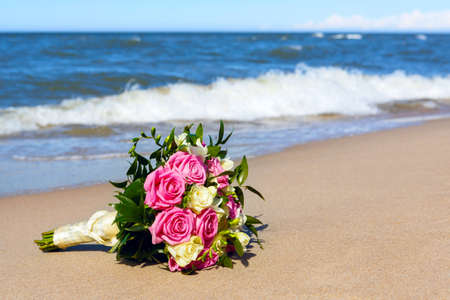 wedding bouquet the bride on background of the seaの写真素材