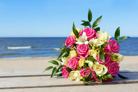 wedding bouquet the bride on background of the seaの写真素材