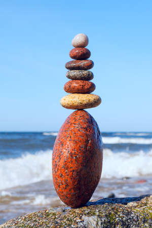 Concept of harmony and balance. Rock Zen on the storm background. Balance and poise stones against the seaの写真素材