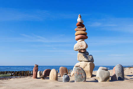 Concept of harmony and balance. Balance and poise stones against the sea. Rock zen against the seaの写真素材