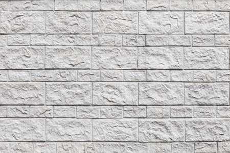 Wall of white bricks and large blocks