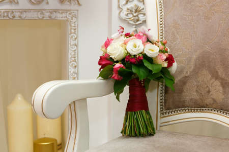beautiful wedding bouquet of red and white roses on chair. Bridal bouquetの写真素材