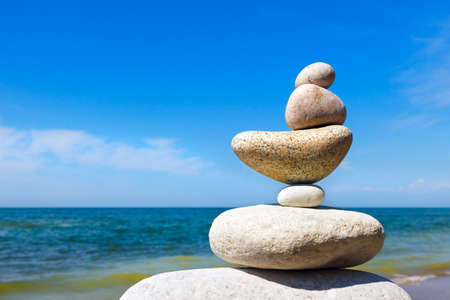 Rock Zen on the background of summer sea. Concept of harmony and balanceの写真素材