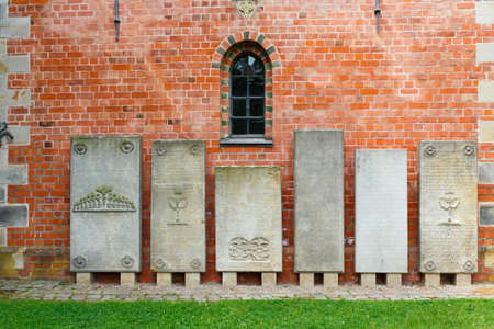Haseldorf, Germany-June 24, 2011:Church of St. Gabriel. old tombstones with inscriptions from the walls of the old Churchのeditorial素材