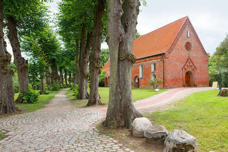 Haseldorf, Germany-June 24, 2011:Church of St. Gabriel. Church of the thirteenth century, built of red brick and the alley in the old Parkのeditorial素材