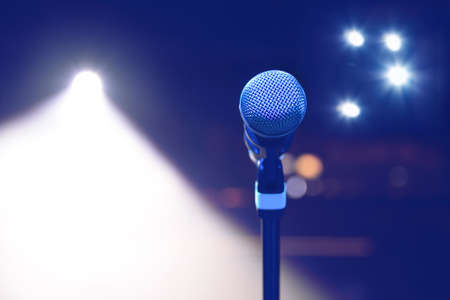 microphone on the background of dark hall and soffits. Soft focus, selective focusの写真素材