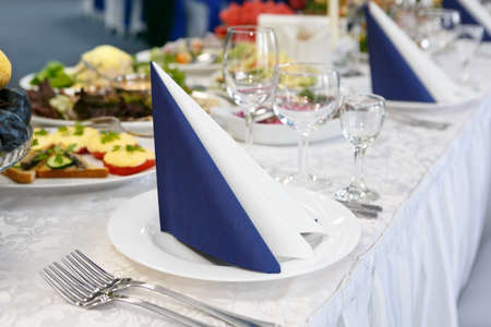 fragment of serving a festive table with blue-white napkin. Soft focus, selective focusの写真素材