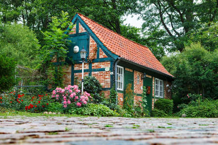 Darmstadt, Germany-June 22, 2011:Small, fairy house with a tiled roof. The house is a workshop for making ceramic productsのeditorial素材