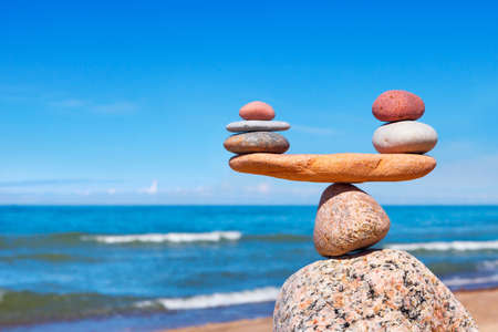 Concept of harmony and balance. Balance stones against the sea. Rock zen in the form of scalesの写真素材