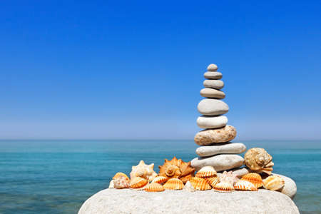 White rock Zen against the background of summer sea and blue sky. Concept of balance, harmony and...