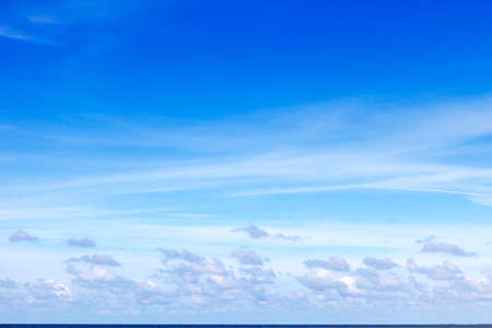 Beautiful summer blue sky over the sea with Cirrus and Cumulus clouds. Background imageの写真素材