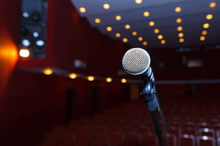 microphone on a background of dark hall with seating for spectators. Preparation for the press conferenceの写真素材